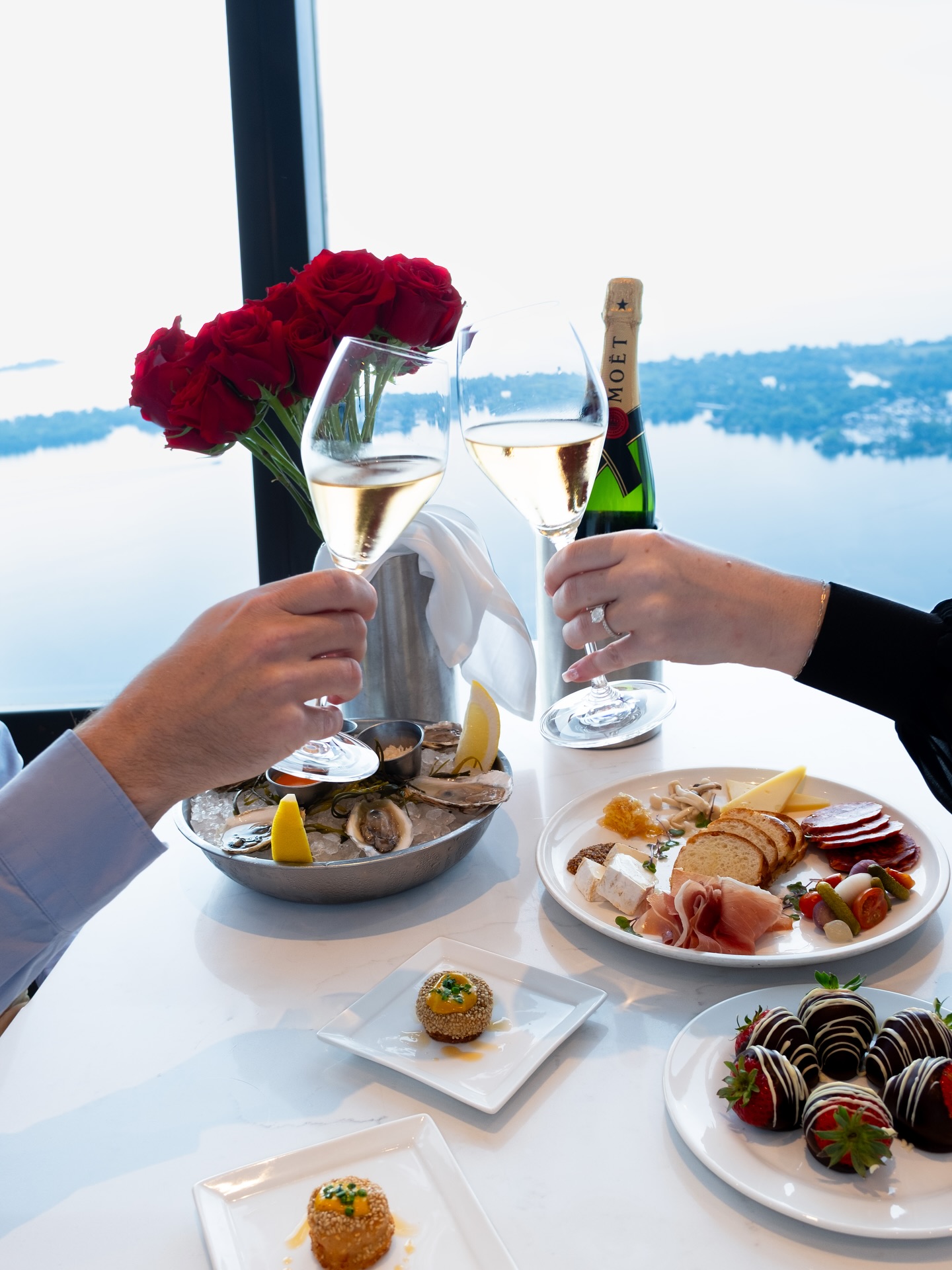 Proposal toast with oysters and sparkling wine at 360 Restaurant overlooking Lake Ontario