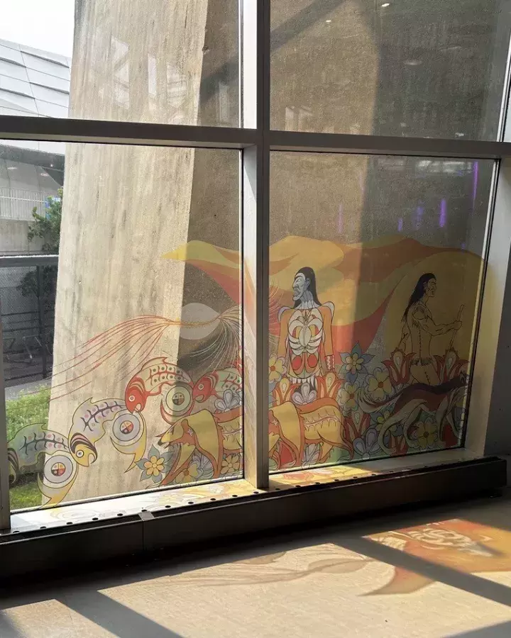 Elements of the mural titled Kiinwin Dabaadjmowin, or Our Story as window clings at the CN Tower